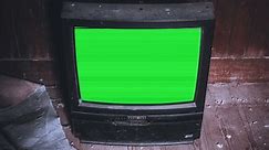 Vintage Broken TV Green Screen Interference Retro Television Zoom In. Vintage television green screen abandoned on the ground of a dirty place, zoom in