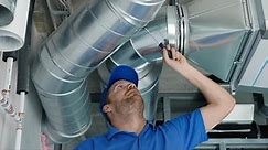 hvac services - worker install ducted system for ventilation and air conditioning with recuperation