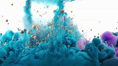 Liquid colors poured into water. Colors mixing in dynamic flow. Blue color waves with Orange Bubbles lifting up.