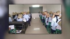 Students wear boxes on their heads during exam to prevent cheating