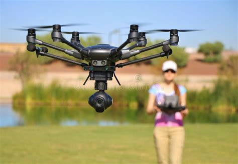woman flying high tech camera drone large file stock photo image  blades green