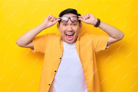 Premium Photo Surprised Young Handsome Asian Man Taking Off Glasses