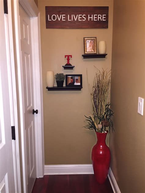 cute idea  decorate     hallway floating shelves large vase picture frames