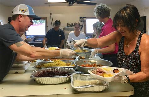 volunteers serve thanksgiving dinners from st mary s