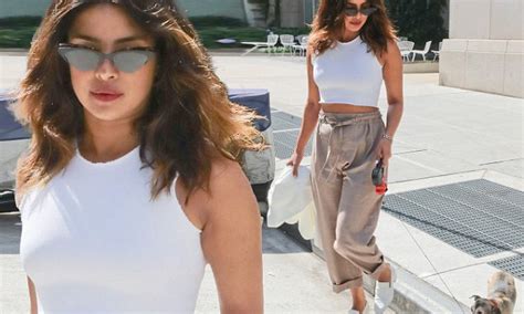 priyanka chopra flashes a hint of her flat abs in tiny white tank while