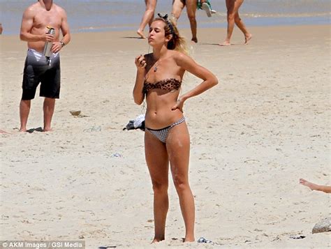 brazilian model alice dellal mixes work with pleasure as she exercises at the beach wearing tiny