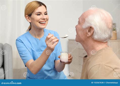 nurse feeding  elderly woman royalty  stock photo cartoondealercom