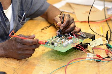 man working   electronic device  wires   electrical equipment