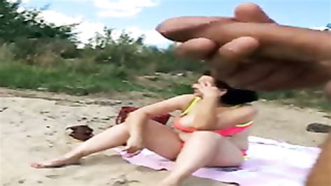 cumming in front of a woman on the beach