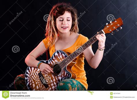 Teenage Girl Singing And Playing Guitar Stock Image
