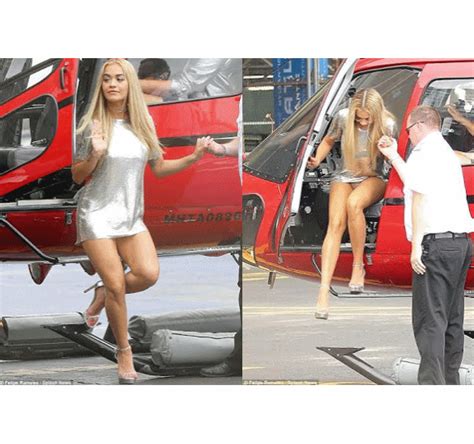 oops singer rita ora flashes underwear while scaling out