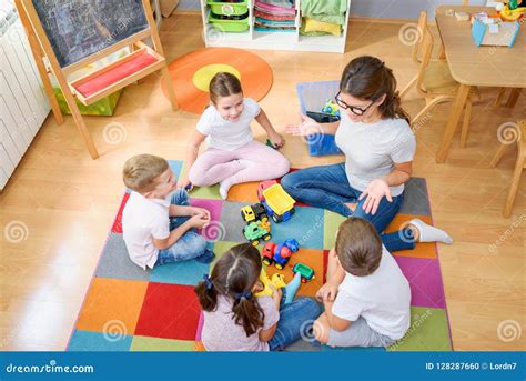 preschool teacher talking  group  children sitting   floor
