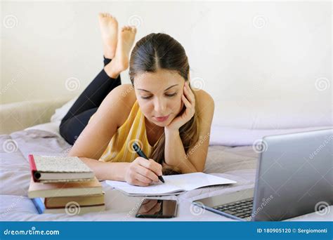 distance learning homeschooling concept pretty teenager girl  homework lying  bed