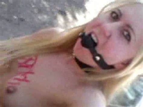 wacky blonde whore with bdsm fetish stands naked outdoor