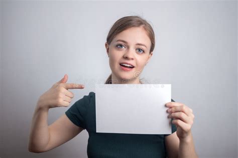 smiling young caucasian woman girl holding blank white paper sheet