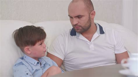 smiling father talking  son sitting  stock footage sbv  storyblocks