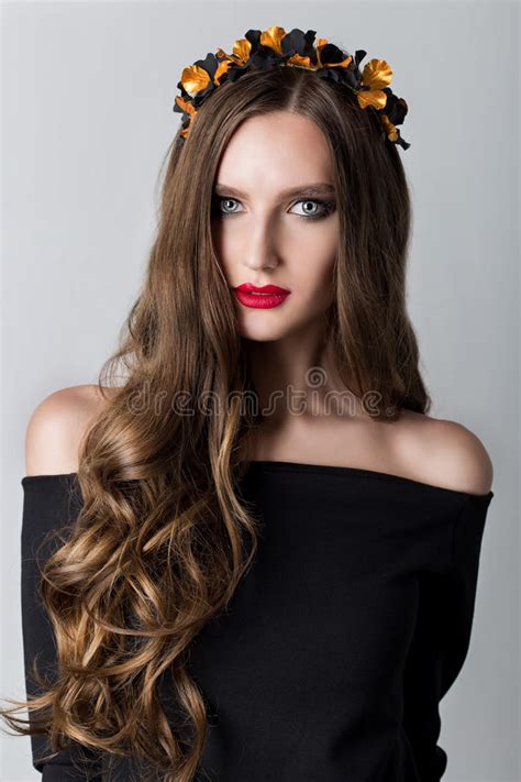beautiful cute skinny girl with long hair with a wreath on his head and bright make up in