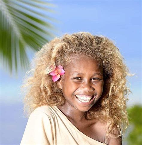 the melanesian people with dark skin and blonde hair