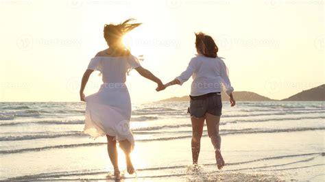 Young Asian Lesbian Couple Running On Beach Beautiful Women Friends