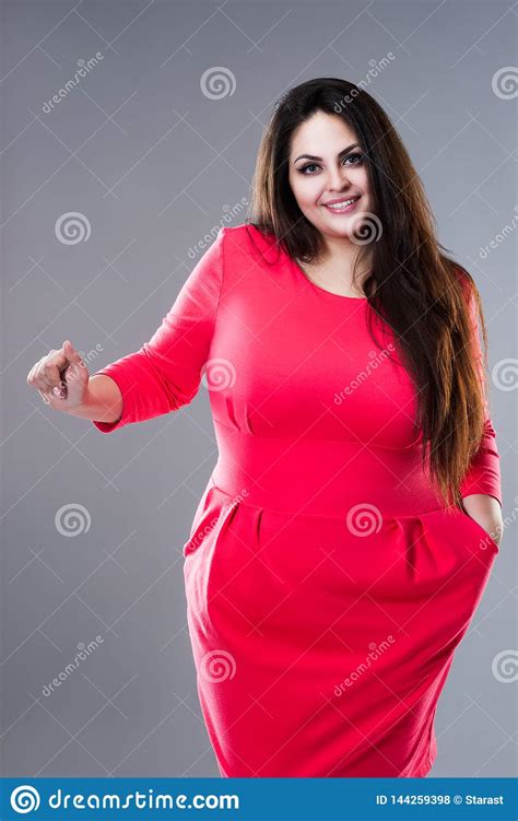 happy brunette plus size model in red dress fat woman with long hair