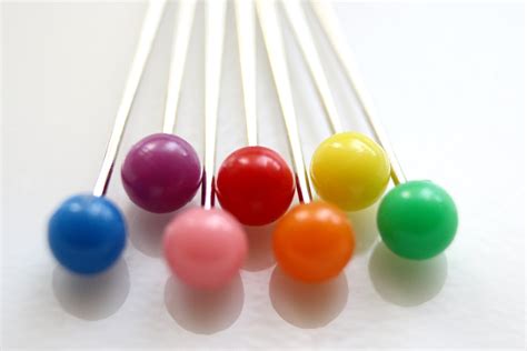 rainbow colored sewing straight pins macro picture  photograph