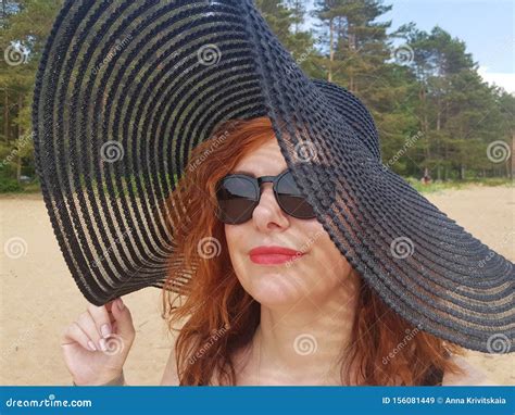 Woman In A Black Wide Brimmed Hat And Sunglasses Portrait Stock Image