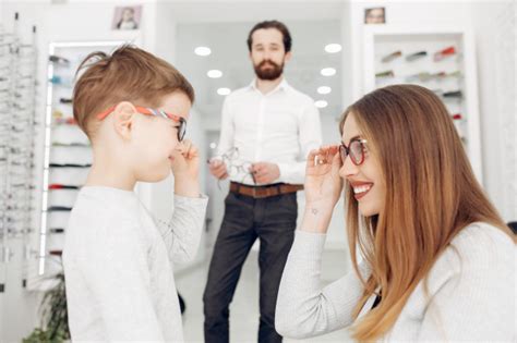 Mother With Little Son In The Glasses Store Photo Free Download