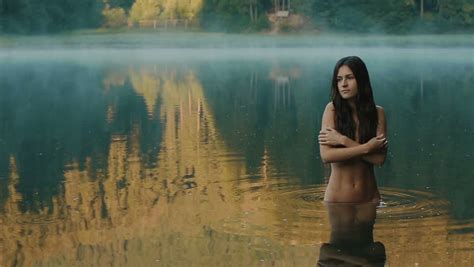 beautiful naked seductive witch in the carpathian lake