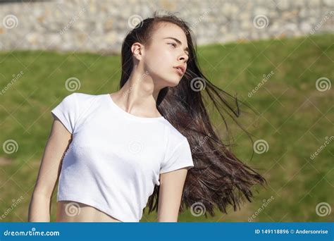 Young Beautiful Teenager Girl Posing Against Summer Park Bright Sunny