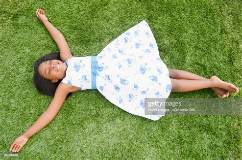 black girl laying in grass photo getty images