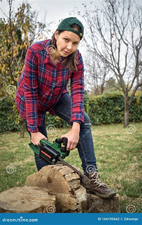 female lumberjack holding  chainsaw stock photo image  cutting