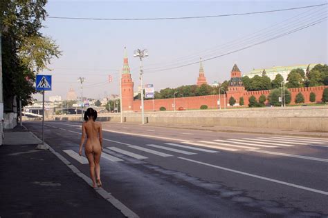 hot russian brunette with ideal body and big boobs posing naked in front of kremlin russian