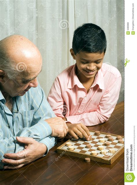 grandfather and grandson sitting on table playing royalty