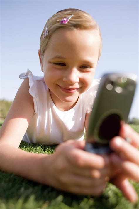 girl using a mobile phone photograph by ian hooton science photo