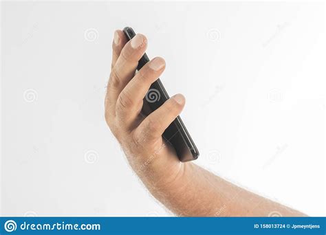 photo detail of a man`s hand holding a black cell phone on