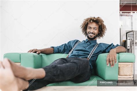 young man relaxed barefoot  armchair  feet  relaxation young
