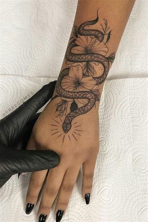 meaningful snake tattoo  hand tattoos  women snake tattoo
