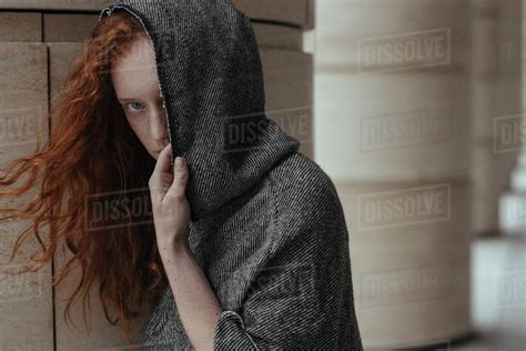 caucasian woman hiding face  hood stock photo dissolve
