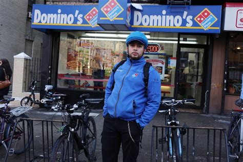 dominos pizza slammed  picture  delivery worker wading  knee deep sewage news