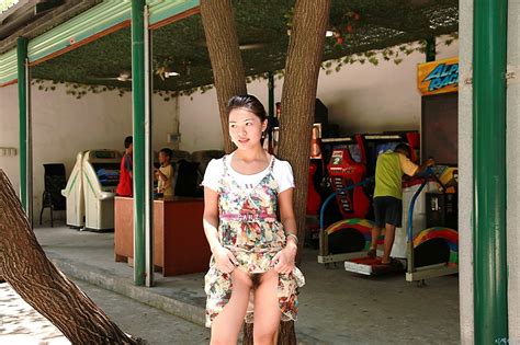 chinese female public flasher at amusement park flashing her hairy pussy sexmenu