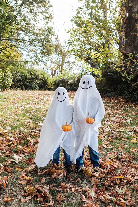 kids  ghost costume celebrating halloween  stocksy
