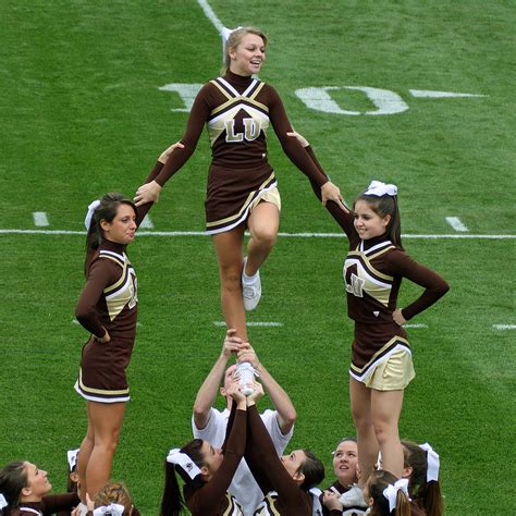cheerleader co captain tries to get a better view of crowd