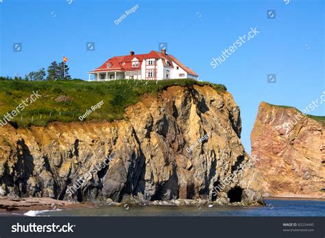 The Red House On Top Of The Cliff On The Edge Of The Water