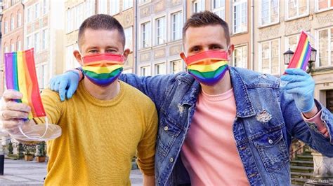 gay couple hands out rainbow masks on the streets of poland