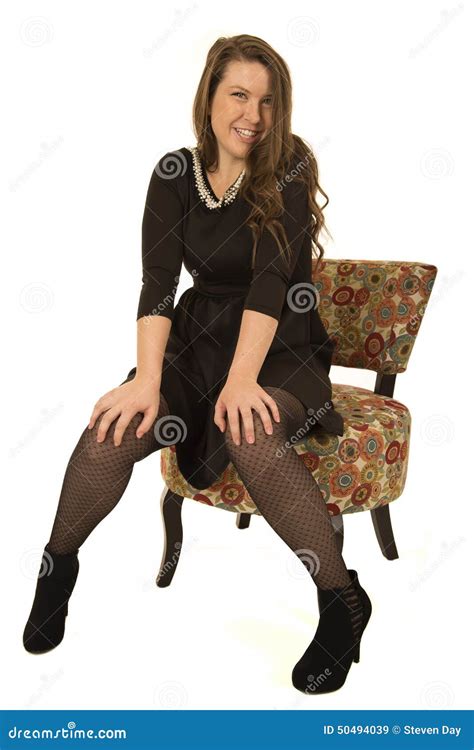 happy female model sitting   floral chair stock photo image