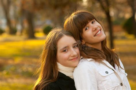 two beautiful happy teenage girls in the park royalty free