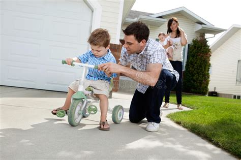 father teaching son to ride tricycle stock image image of mother little 22212283