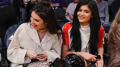 kendall and kylie jenner sport crazy thigh high boots at lakers game