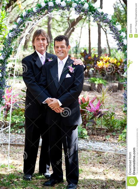 gay couple under wedding arch royalty free stock images