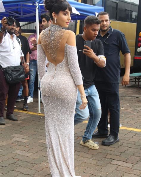 Glamour Queen Nora Fatehi Sizzles The White Sequin Thigh High Slit Gown